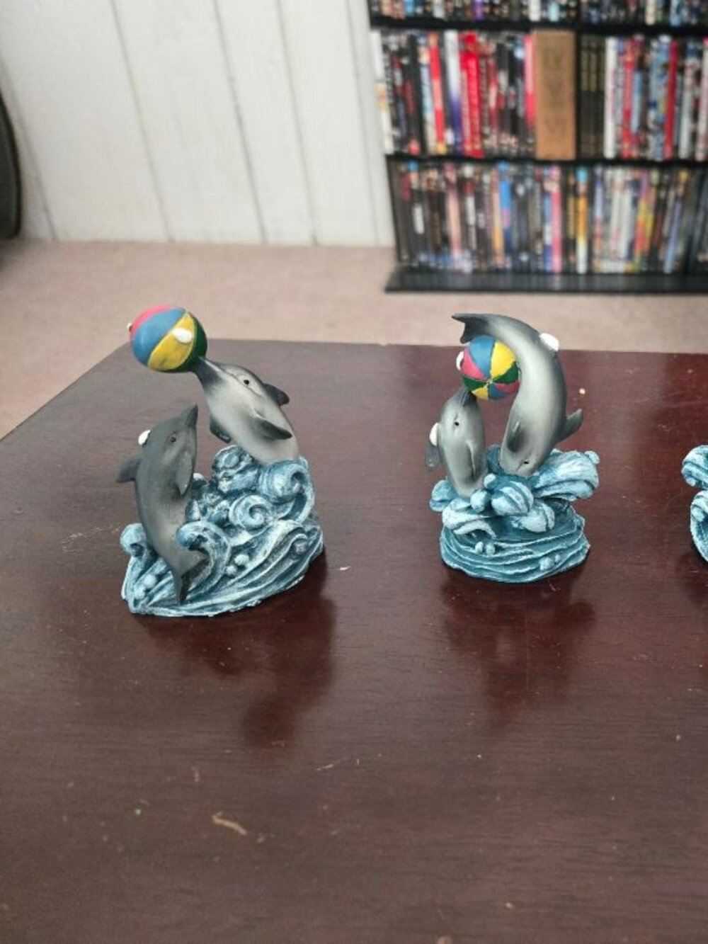 4 dolphins playing with beach balls